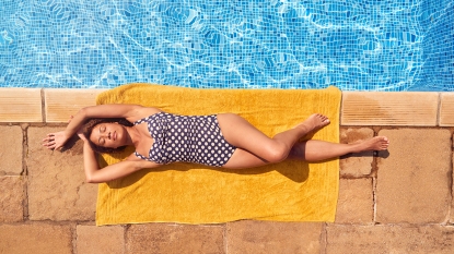 A woman lying down in the sun after losing the water weight